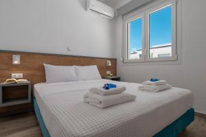 a bedroom with a bed with towels on it at SLV Danai 7 Apartments in Ofrínion +42 photos
