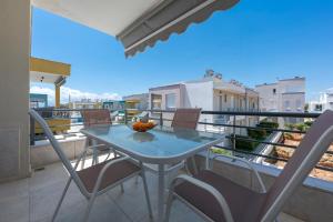 a table and chairs on a balcony with a view at SLV Danai 7 Apartments in Ofrínion
