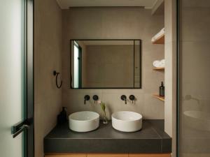 a bathroom with two sinks and a mirror at Nostos - Luxury Apartment in Agrinio in Agrinio +14 photos