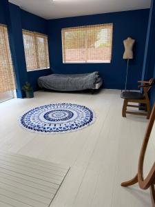 a blue room with a bed and a rug on the floor at MIYARA GARDEN House in Ishigaki Island