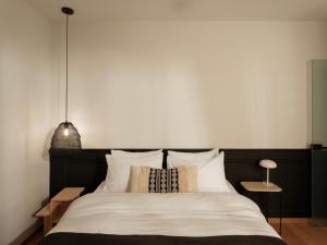 a bedroom with a large bed with white sheets and pillows at Nostos - Luxury Apartment in Agrinio in Agrinio