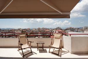 two chairs and a table on a balcony at Nostos - Luxury Apartment in Agrinio in Agrinio
