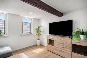a living room with a flat screen tv on a wooden dresser at Haus Mersche in Gösenroth