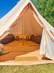 a large white tent with a bed in it at Glamping Arctic Ukuli in Rovaniemi