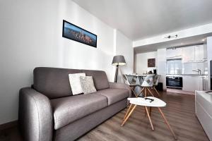 a living room with a couch and a table at One-bedroom apt with balcony on Rue Hoche in Cannes