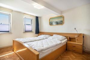 a bedroom with a bed and a mirror on the wall at Haus Mersche in Gösenroth