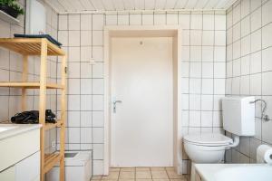 a white bathroom with a toilet and a sink at Haus Mersche in Gösenroth +25 photos