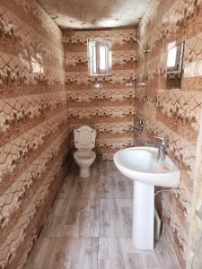 a bathroom with a sink and a toilet at Teo's cottage in Maradidi