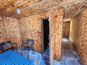 a room with two chairs and a bed in it at Teo's cottage in Maradidi +9 photos