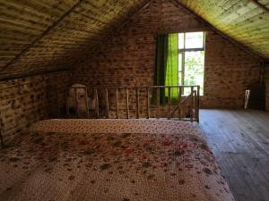 a bedroom with a bed in a room with a window at Teo's cottage in Maradidi