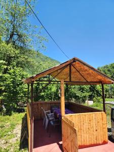 a wooden gazebo with a table and chairs at Teo's cottage in Maradidi