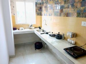 a kitchen with a sink and a counter top at O2 Homes in Guwahati +23 photos