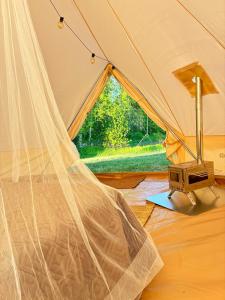 a tent with a sewing machine in front of a window at Glamping Arctic Ukuli in Rovaniemi