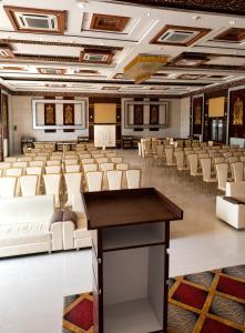 a large room with white chairs and a table at Hotel Panigrahan in Bikaner