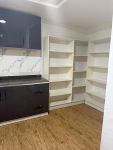 a room with white shelves and a flat screen tv at Pristine Residences Premium 2 Bedroom Apartment Ajah Lagos in Lekki