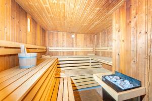 a sauna with wooden walls and a wooden floor at The Great View Sauna & more in Harscheid