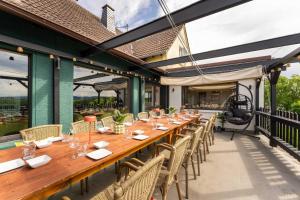 a long wooden table and chairs on a patio at The Great View Sauna & more in Harscheid