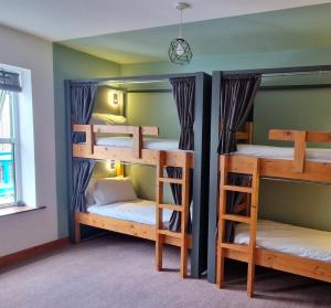 a room with three bunk beds in it at Glengarriff Hostel in Glengarriff