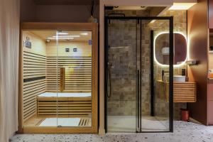 a bathroom with a shower and a glass door at Suite romantique Ibiza, Jacuzzi, Spa in Strasbourg