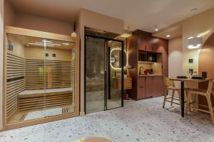 a kitchen with a glass door leading into a kitchen with a table at Suite romantique Ibiza, Jacuzzi, Spa in Strasbourg +39 photos