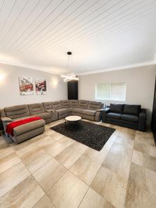 a living room with a couch and a table at Ridgeworth Royale in Tyger Valley +19 photos