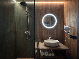 a bathroom with a sink and a shower with a mirror at Котедж Gudz in Yaremche +19 photos