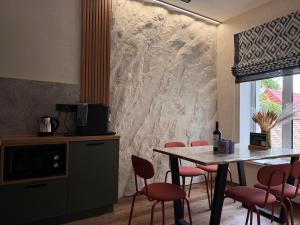 a dining room with a table and red chairs at Котедж Gudz in Yaremche