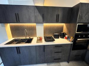 a small kitchen with a sink and a microwave at Ridgeworth Royale in Tyger Valley
