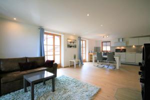 a living room with a couch and a table at Ferienwohnung Am Mühlbach 1 in Halblech