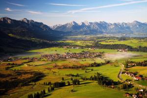 an aerial view of a town in a valley with mountains at Ferienwohnung Am Mühlbach 1 in Halblech