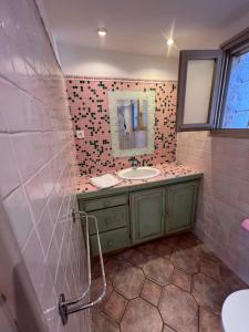 a bathroom with a sink and a mirror at Residence La Beloutiere in Porto-Vecchio +31 photos