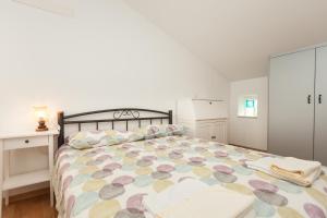 a bedroom with a large bed with a colorful bedspread at Apartment Amare in Rovinj