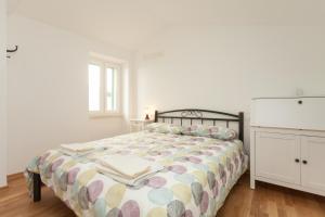 a bedroom with a bed and a dresser at Apartment Amare in Rovinj