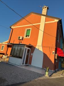 an orange building with a door and a window at Casa di Nonni in I Forti +15 photos