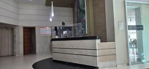 a lobby with a reception desk in a building at Alugo Suite 303 No Mont Blanc in Nova Iguaçu