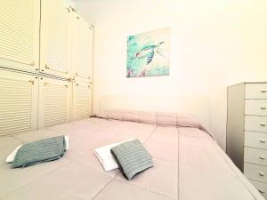 a bedroom with a bed with two pillows on it at DIMORA Concept - Yellow Apartment in Ceriale