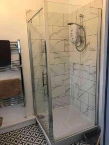 a shower with a glass door in a bathroom at 8 Bedroom House For Corporate Stays in Kettering in Kettering