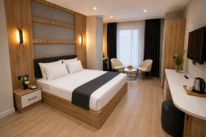 a hotel room with a bed and a desk at Golden River Hotel By Continent in Arnavutköy +16 photos