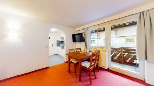 a dining room with a table and chairs and a television at Wohnhaus Christoph in Längenfeld