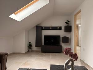 a living room with a flat screen tv on a wall at Apartment Ivan in Karlobag