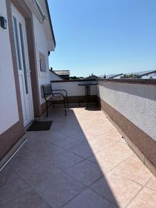 a patio with a table and a chair on a balcony at Apartment Ivan in Karlobag