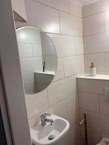 a bathroom with a sink and a mirror at Apartment Ivan in Karlobag +7 photos