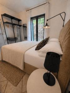 a bedroom with a bed and a chair and a window at Riviera Panorama Retreat in Alassio +28 photos