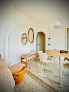 a living room with a table and a table and chairs at Riviera Panorama Retreat in Alassio