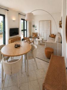 a living room with a table and a couch at Riviera Panorama Retreat in Alassio