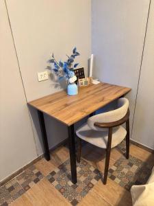 a wooden table with a vase on top of it at ИксаОтель in Shymkent