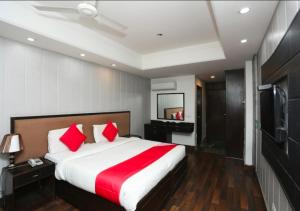 a bedroom with a large bed and a television at The Avenue Residency in Gurgaon
