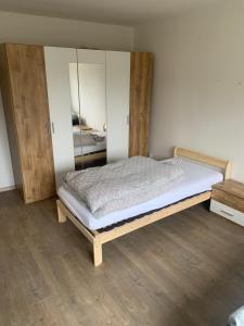 a bedroom with a bed in a room with wooden floors at Your Home 27 with parking in Myslava
