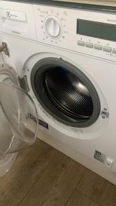 a white washing machine with its door open at Your Home 27 with parking in Myslava