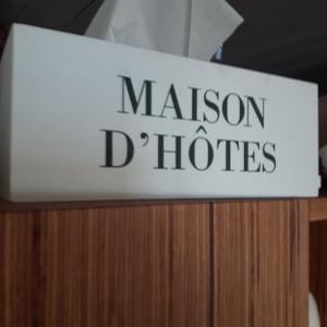 a sign that says malcolm d horizons on top of a cabinet at Les Volets Bleus Alsace Vosges in Urbès